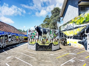 A parking lot with a mural of a cow and a train. - OYO Homes 91132 Desa Wisata Kalipucang (Purwosari)