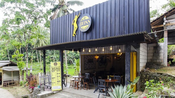 A rustic cafe with a corrugated metal roof and a signboard displaying the menu. - OYO Homes 91134 Desa Wisata Tebing Lingga (Nglebo)