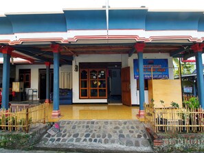 A building with a covered entrance, a wooden fence, and a tiled floor. - OYO Homes 91134 Desa Wisata Tebing Lingga (Nglebo)