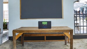 A room with a wooden table, a blackboard, and a blackboard eraser on the table. - OYO 91011 Eco Tourism Desa Cibodas Areng 1 Syariah (Lembang)
