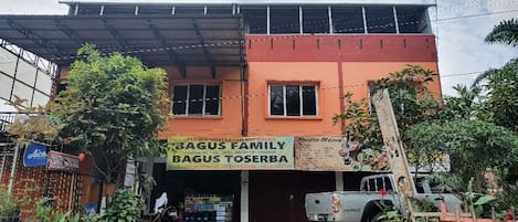A two-story building with a sign for 'BAGUS FAMILY BAGUS TOSERBA' indicating a family-owned business.