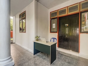 A room with a desk, chair, and a window.