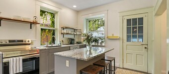Historic house on tree lined red brick street of historic homes.