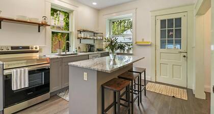 Historic house on tree lined red brick street of historic homes.