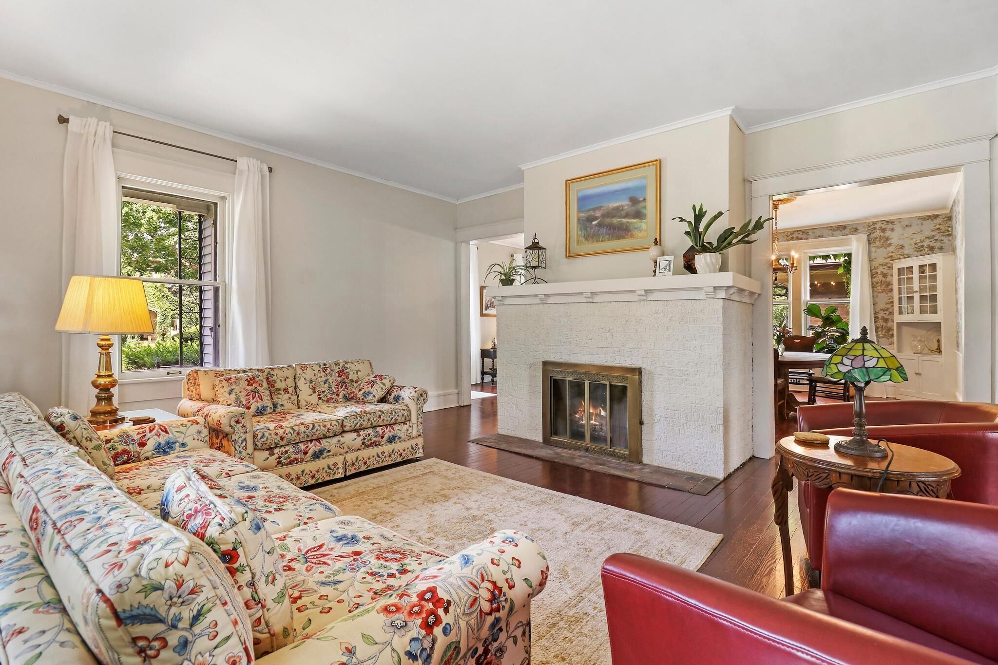 Historic house on tree lined red brick street of historic homes.