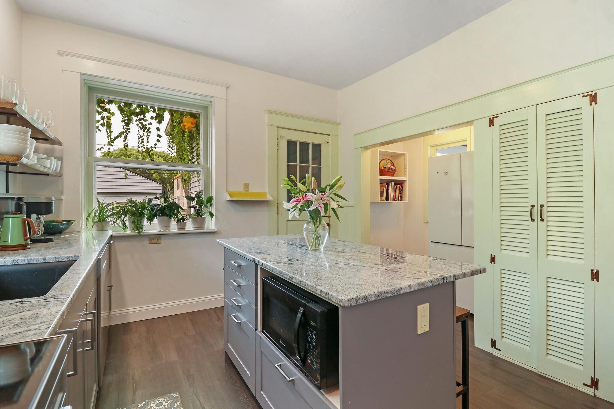 Historic house on tree lined red brick street of historic homes.