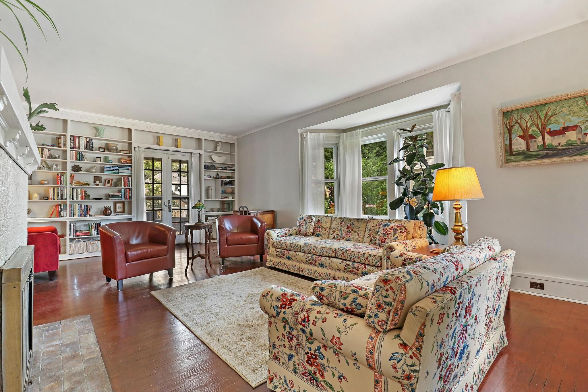 Historic house on tree lined red brick street of historic homes.