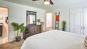 A bedroom with a bed, a ceiling fan, a dresser, and a mirror. - Charming Springfield Escape w/ Furnished Deck (Springfield)