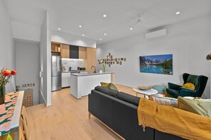 Deluxe Townhome | Living area | 65-inch Smart TV with digital channels, TV, Netflix - StayCentral - Boulevard Gardens (Coburg)