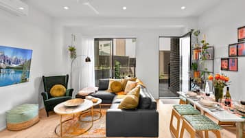 Deluxe Townhome | Living area | 65-inch Smart TV with digital channels, TV, Netflix