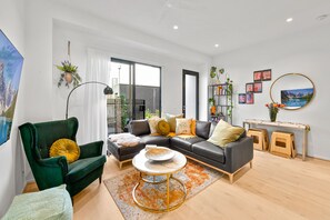 Deluxe Townhome | Living area | 65-inch Smart TV with digital channels, TV, Netflix - StayCentral - Boulevard Gardens (Coburg)