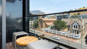 A balcony with a view of a street, a church, and a mountain. - The Signature 414 (Cape Town)