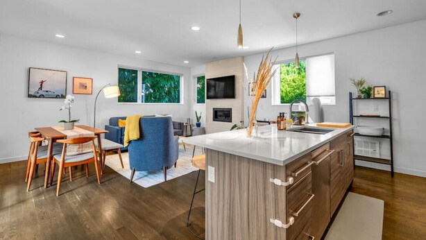 A modern kitchen with a central island, wooden cabinets, and a built-in oven. - 4313 Fremont · 3b2.5b Fremont Gem w/ Seattle Skyline & Lake View (Seattle)