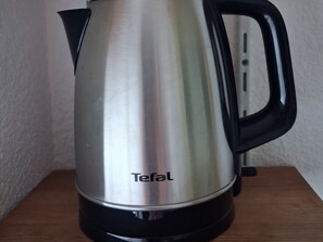 A stainless steel Tefal electric kettle with a black handle and base, placed on a wooden surface. - Cozy central studio, balcony, near slopes (La Plagne Montchavin Les Coches)