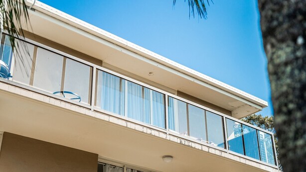 A balcony with a railing, a window, and a ceiling light. - Summer Salt - walk across road to beach, easy walk to town (Byron Bay)