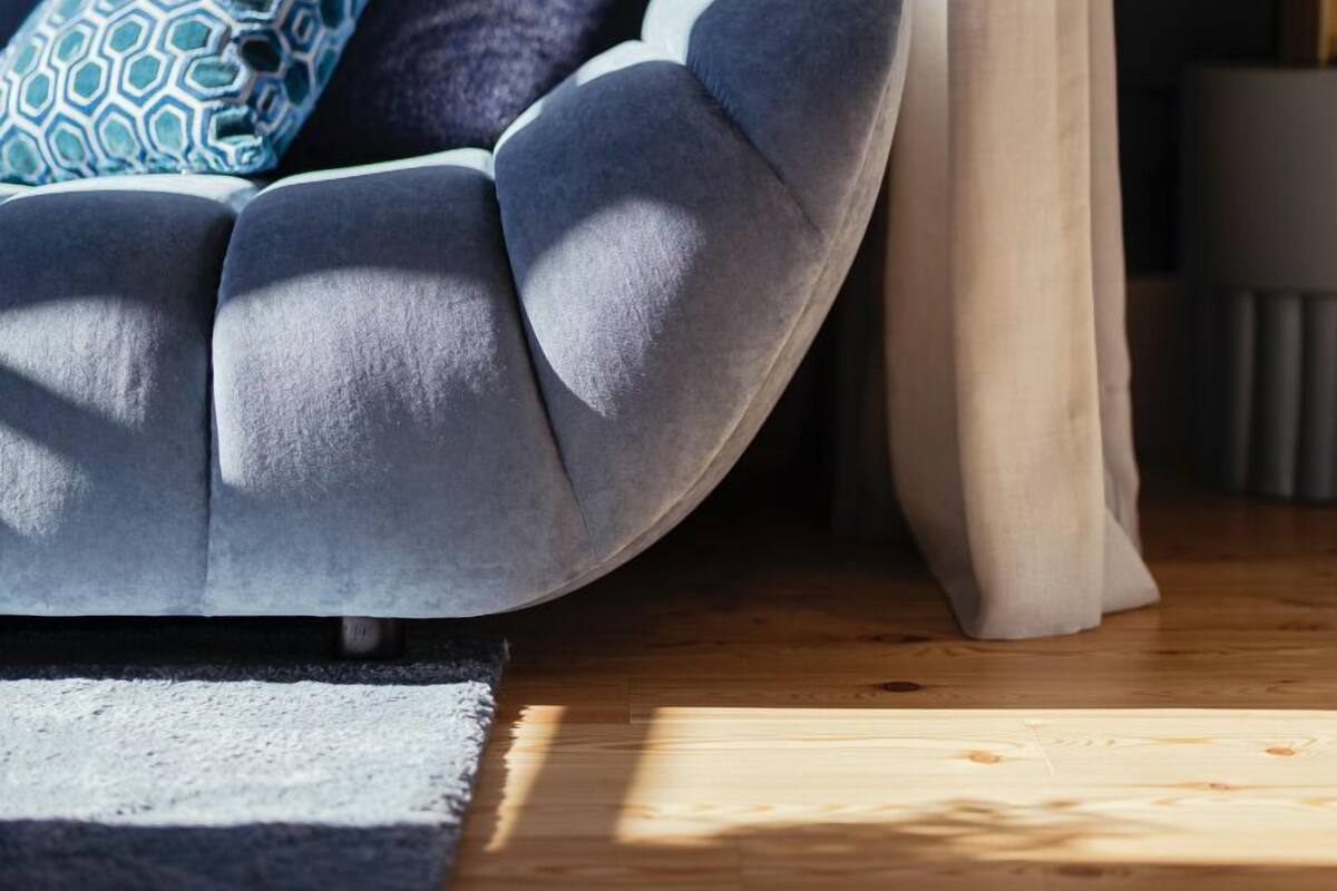 A cozy seating area with a cushioned chair and a patterned pillow.