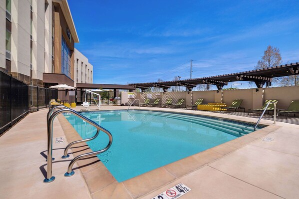 Alberca al aire libre, sombrillas en la alberca y camastros 