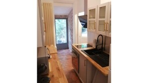 A compact kitchen with a built-in stove, a sink, and a window. - Nice, friendly house near Paris (Argenteuil)
