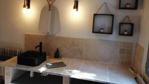 A bathroom with a sink, mirror, towel rack, and wall-mounted lights. - Nice, friendly house near Paris (Argenteuil)