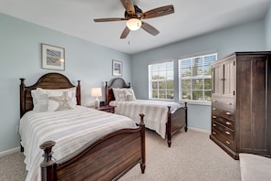 A bedroom with two beds, a ceiling fan, a dresser, and a window with blinds. - Stunning Villa with spectacular views in an amazing location B1813A+* (Cape Haze)