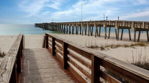 Walk along the pier and enjoy the serene beach views.