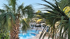 A pool surrounded by palm trees and a clear blue sky. - Dog Friendly, Close to Beach, Overlooks Pool/Spa + Free Attraction Tickets! (Santa Rosa Beach)