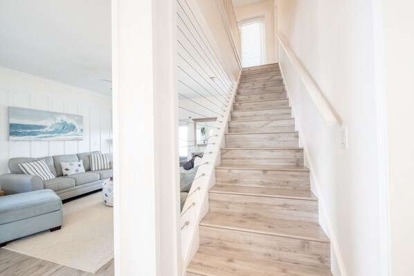 A staircase with wooden steps and white walls.