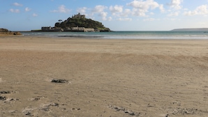 A beach with a castle on a small island in the background. - Marazion Attic (Marazion)