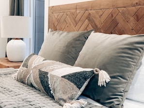 Restful retreat with a cozy bed, wooden headboard, and elegant decor.