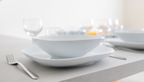A dining table with white plates and cutlery. - Italianway - The B Village Superior (Milan)