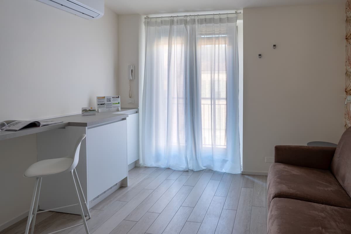 A compact living space with a kitchenette, a dining area, and a seating area.