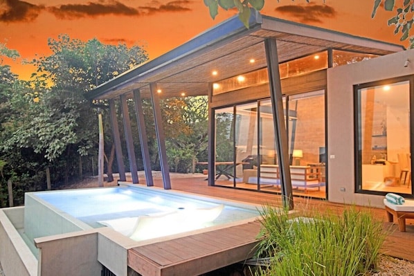 A modern house with a swimming pool, large windows, and a covered patio. - Casa La Reina, Private Jungle Villa (Tamarindo)