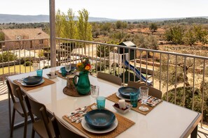 Une table à manger installée à l’extérieur, offrant une vue sur un paysage rural.