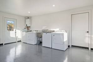 A laundry room with a washing machine, dryer, and a water heater.