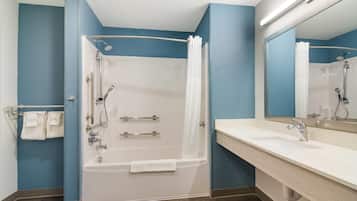 Un baño moderno con bañera, ducha y lavamanos dobles.