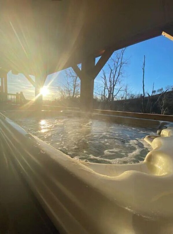 Relax in a serene hot tub surrounded by a peaceful garden oasis.