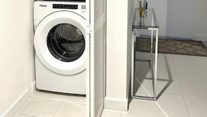 A laundry room with two stacked front-loading washing machines. - A1608 AWESOME Downtown Doral Apartment (Doral)