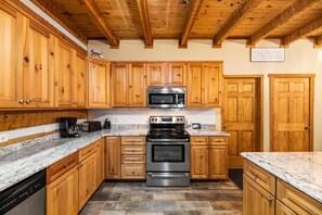 Enjoy cooking in this well-equipped kitchen with a stainless steel oven, microwave, and ample countertop space.