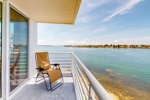 Enjoy breathtaking views of the calm body of water from this balcony.