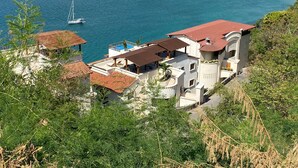 A coastal property with a swimming pool, a beach, and boats in the water. - Luxurious Pacifica Grand Senior Suite (Zihuatanejo)