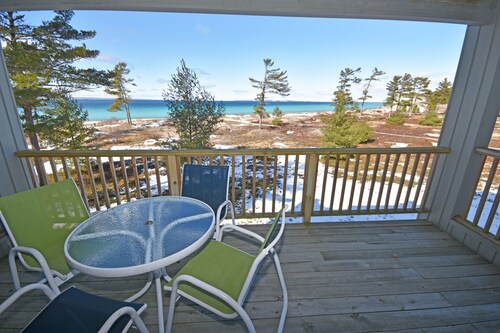 Beachfront condo with gorgeous Lake Michigan views, deck, fireplace, W/D, AC