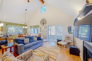 Relax in this inviting living area with a fireplace, sofa, and dining space.