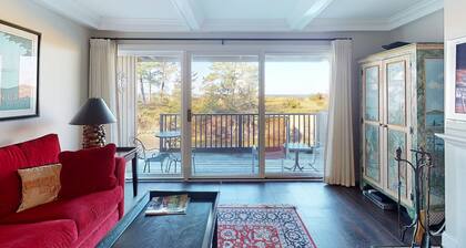 Riverfront condo with beach access to lake, fireplace, furnished deck & cable