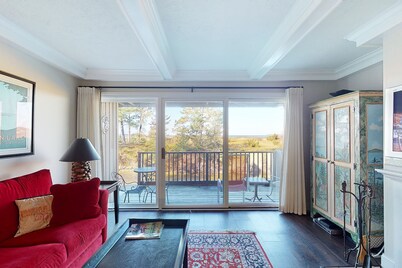 Riverfront condo with beach access to lake, fireplace, furnished deck & cable