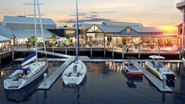 A marina with several boats docked, a building with a modern design, and a sunset in the background. - Barefoot Buddina Laid-Back Pet Friendly by the Sea (Buddina)