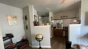 A living room with a wooden floor, a globe on a stand, a bookshelf, and a bench. - Sunrise Bluff Lakefront - in family-friendly area w/ great view of Grand Lake (Grove)