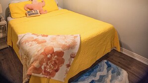 A bedroom with a bed, a nightstand, a wall-mounted shelf, and three wall art pieces. - Sunrise Bluff Lakefront - in family-friendly area w/ great view of Grand Lake (Grove)