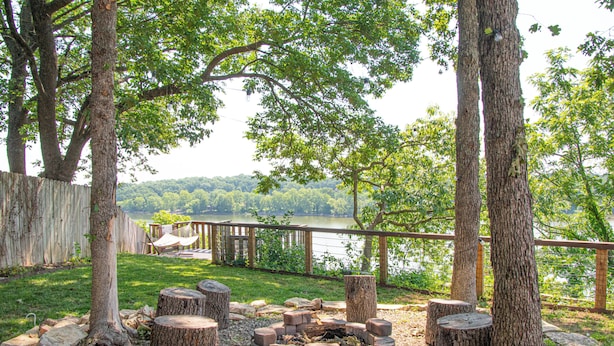 A lakeside deck with a fire pit, wooden deck, and a view of the lake. - Sunrise Bluff Lakefront - in family-friendly area w/ great view of Grand Lake (Grove)