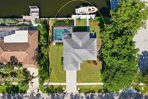 Exterior - Chic canal-front home with dock, enclosed lanai, WiFi, A/C, bikes, & W/D (Marco Island)