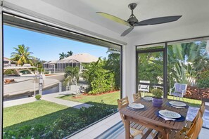 Outdoor dining - Chic canal-front home with dock, enclosed lanai, WiFi, A/C, bikes, & W/D (Marco Island)